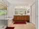 Bathroom featuring wood cabinets, dual vanity, soaking tub, and large glass shower at 12511 Se 91St Terrace Rd, Summerfield, FL 34491