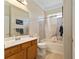 Neutral bathroom featuring a tub with a shower and a single sink vanity with cabinets at 12511 Se 91St Terrace Rd, Summerfield, FL 34491