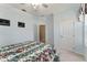 Bright bedroom features a ceiling fan, neutral carpet, and walk-in closet at 12511 Se 91St Terrace Rd, Summerfield, FL 34491