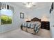 Bright bedroom features a ceiling fan, neutral carpet, and large window views at 12511 Se 91St Terrace Rd, Summerfield, FL 34491