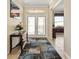 Inviting foyer with decorative rug and view to living area with natural light at 12511 Se 91St Terrace Rd, Summerfield, FL 34491