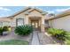 Up close view of the front entrance, framed by palm trees and elegant landscaping at 12511 Se 91St Terrace Rd, Summerfield, FL 34491