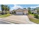 Charming single story home with a patterned driveway and a two-car garage at 12511 Se 91St Terrace Rd, Summerfield, FL 34491