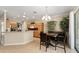 Bright kitchen with wooden cabinetry and adjacent dining area with tile flooring at 12511 Se 91St Terrace Rd, Summerfield, FL 34491