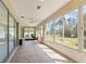 Enclosed lanai area with tiled floors, ceiling fan, sliding glass doors, and workout equipment at 12511 Se 91St Terrace Rd, Summerfield, FL 34491