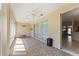 Enclosed lanai area with tiled floors, ceiling fan, and sliding glass door at 12511 Se 91St Terrace Rd, Summerfield, FL 34491