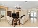 Comfortable living room with tile floors, ceiling fan, and a view of the foyer at 12511 Se 91St Terrace Rd, Summerfield, FL 34491