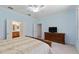Spacious main bedroom features a ceiling fan, neutral carpet, and traditional dresser at 12511 Se 91St Terrace Rd, Summerfield, FL 34491
