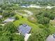 Stunning aerial view of home with screened pool, mature trees and a large lake at 13112 Luntz Point Ln, Windermere, FL 34786
