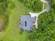 Aerial view of a private home with a screened pool surrounded by lush greenery and mature trees at 13112 Luntz Point Ln, Windermere, FL 34786