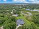 Gorgeous aerial view of the home surrounded by lush greenery and a picturesque lake at 13112 Luntz Point Ln, Windermere, FL 34786