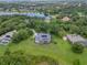 Aerial view of the home showcasing the screened-in pool and a large backyard overlooking the lake at 13112 Luntz Point Ln, Windermere, FL 34786
