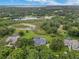 An inviting aerial view of the home site and the community lake and trees at 13112 Luntz Point Ln, Windermere, FL 34786