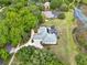 Aerial view of a home with a pool and large yard surrounded by lush trees at 13112 Luntz Point Ln, Windermere, FL 34786