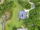 An aerial view of a home nestled in a neighborhood with mature trees and well-maintained lawns at 13112 Luntz Point Ln, Windermere, FL 34786