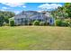 Large screened-in lanai and meticulously landscaped backyard of this beautiful single-Gathering home at 13112 Luntz Point Ln, Windermere, FL 34786