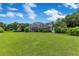 Large screened-in lanai visible from the backyard, complemented by lush tropical landscaping at 13112 Luntz Point Ln, Windermere, FL 34786
