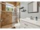 Bathroom featuring a glass shower, tiled walls, sleek white vanity, and modern fixtures at 13112 Luntz Point Ln, Windermere, FL 34786