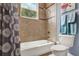 Bathroom with shower-tub combination, window, and blue walls at 13112 Luntz Point Ln, Windermere, FL 34786