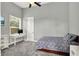 Neutral bedroom showcasing a comfortable bed, large window and grey color scheme at 13112 Luntz Point Ln, Windermere, FL 34786
