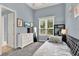 Comfortable bedroom featuring cozy daybed, grey carpet, and bright window at 13112 Luntz Point Ln, Windermere, FL 34786