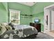 Cozy bedroom with two-tone green walls and neutral carpet at 13112 Luntz Point Ln, Windermere, FL 34786