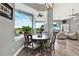Breakfast nook with round table and expansive window offering views of the pool and backyard at 13112 Luntz Point Ln, Windermere, FL 34786