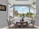 Breakfast nook with a round table and chairs offering views of the screened-in pool and backyard at 13112 Luntz Point Ln, Windermere, FL 34786