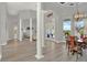 Formal dining area with high ceilings, decorative columns, wood table set, and natural light streaming in from the patio at 13112 Luntz Point Ln, Windermere, FL 34786