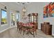 Elegant dining room featuring formal table set, china cabinet, artwork, and a patio view through French doors at 13112 Luntz Point Ln, Windermere, FL 34786