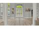 Grand foyer with double doors, high ceilings, natural light, and light colored wood-look flooring at 13112 Luntz Point Ln, Windermere, FL 34786