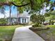 Beautifully landscaped front exterior showing stone tiled roof and circular driveway at 13112 Luntz Point Ln, Windermere, FL 34786