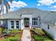 Beautiful home with a tile roof, lush landscaping, and a welcoming entrance at 13112 Luntz Point Ln, Windermere, FL 34786