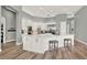 Spacious kitchen featuring white cabinetry, stainless steel appliances, granite countertops, and breakfast bar at 13112 Luntz Point Ln, Windermere, FL 34786