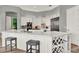 Bright kitchen features white cabinets, quartz countertops, a wine rack, and stainless steel appliances at 13112 Luntz Point Ln, Windermere, FL 34786