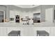 Open-concept kitchen with white cabinets, quartz countertops, and stainless steel appliances at 13112 Luntz Point Ln, Windermere, FL 34786