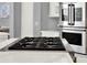 Close up of gas cooktop and stainless oven at 13112 Luntz Point Ln, Windermere, FL 34786