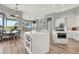 Modern white kitchen with a large island, stainless steel appliances, and open access to living area at 13112 Luntz Point Ln, Windermere, FL 34786
