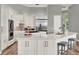 Beautiful kitchen featuring white cabinets, granite countertops, stainless appliances, dual islands, and breakfast bar at 13112 Luntz Point Ln, Windermere, FL 34786
