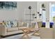 Close-up of a stylish living room, showcasing the decor, furniture, and view of the patio through French doors at 13112 Luntz Point Ln, Windermere, FL 34786