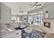 Bright, open-plan living room features stylish decor, a fireplace, and a seamless indoor-outdoor flow to the covered patio at 13112 Luntz Point Ln, Windermere, FL 34786