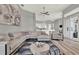 Open-concept living room with modern gray interior design connects to the kitchen, featuring a large sectional and decor at 13112 Luntz Point Ln, Windermere, FL 34786