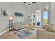 Cozy living room with neutral tones, floral accents, modern art, and French doors with natural light flowing through at 13112 Luntz Point Ln, Windermere, FL 34786