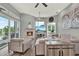 Comfortable living room with stone fireplace, TV, ceiling fans, and comfortable seating arrangement at 13112 Luntz Point Ln, Windermere, FL 34786