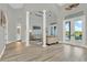 Open living room featuring high ceilings, columns, and a view of the backyard and pool at 13112 Luntz Point Ln, Windermere, FL 34786