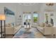 Inviting living room featuring neutral decor, natural lighting, patio views, and sophisticated design details at 13112 Luntz Point Ln, Windermere, FL 34786