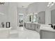 Bright bathroom with a makeup vanity, a freestanding tub, and a walk-in shower at 13112 Luntz Point Ln, Windermere, FL 34786