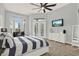 Beautiful bedroom features a ceiling fan, cozy chair, and French doors accessing the pool area at 13112 Luntz Point Ln, Windermere, FL 34786