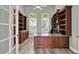 Spacious office featuring beautiful custom built-ins, wood floors, and ample natural light at 13112 Luntz Point Ln, Windermere, FL 34786