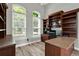 Well-appointed office space with custom built-in shelving, a modern desk, and bright natural light at 13112 Luntz Point Ln, Windermere, FL 34786